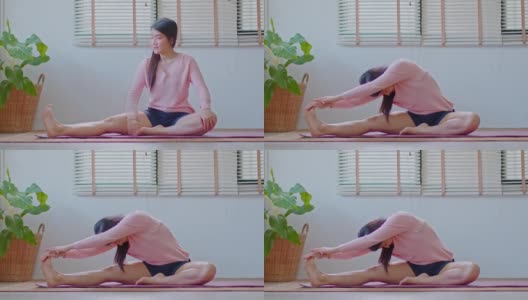 平静的亚洲女性在休闲伸展肌肉热身呼吸和冥想与瑜伽在家，健康的女性做瑜伽感觉如此舒适和放松，健康瑜伽保健概念高清在线视频素材下载