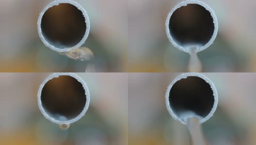 水从PVC管道塑料管与彩色模糊的背景高清在线视频素材下载