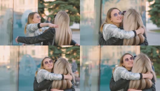 女孩重聚年轻的朋友拥抱城市街道高清在线视频素材下载