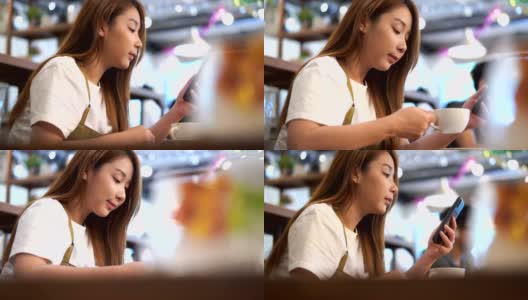 近距离观察一个亚洲女人用手机填满睡意，在周末的咖啡馆喝咖啡高清在线视频素材下载