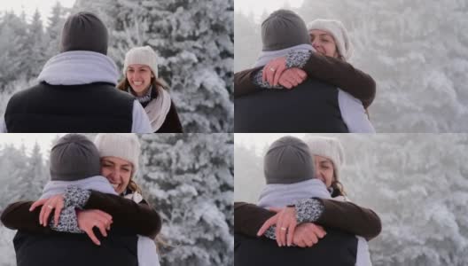 快乐的年轻夫妇拥抱户外自然冬季雪高清在线视频素材下载