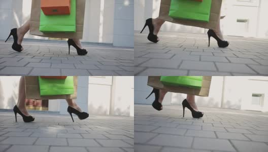 销售，消费主义:穿着高跟鞋拎着购物袋的自信女士高清在线视频素材下载
