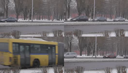 汽车在城市街道上行驶。冬天的时候，雪花飘落。贝尔格莱德城高清在线视频素材下载