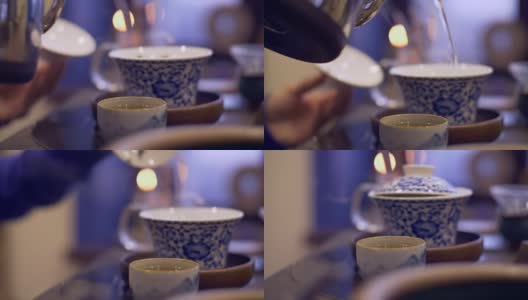 桌上放着一杯热茶。男用手倒热水冲泡茶高清在线视频素材下载