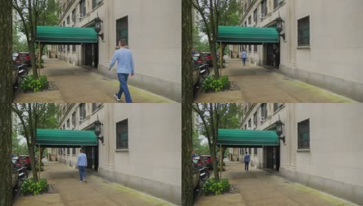 一名男子走过曼哈顿公寓大楼的入口高清在线视频素材下载