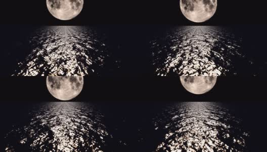 夜晚，深褐色的月亮在海面上缓缓落下高清在线视频素材下载