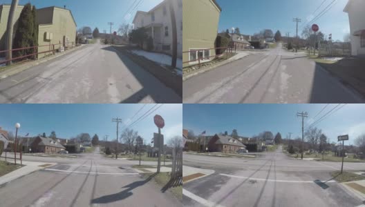 在一个阳光明媚的下午，一辆汽车在一个北美小镇的十字路口刹车高清在线视频素材下载