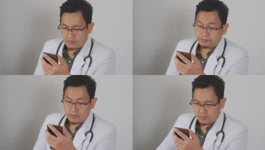 亚洲男医生在网上做研究，浏览上网他的手机高清在线视频素材下载