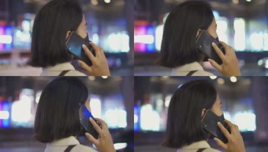亚洲女人一边等出租车一边打电话高清在线视频素材下载