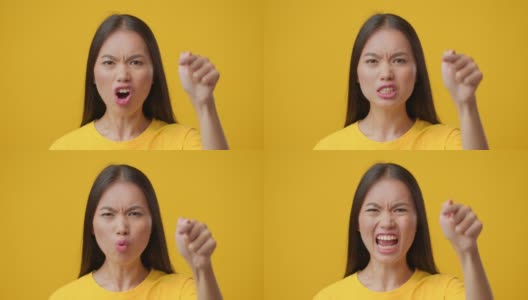愤怒的韩国女性用手指指责某人，黄色背景高清在线视频素材下载