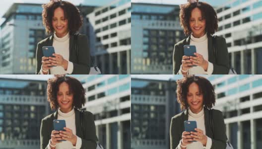 一名女商人在城市里使用智能手机的4k视频高清在线视频素材下载