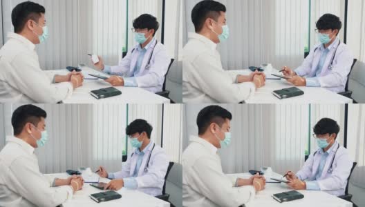 医生们正在解释在病毒爆发期间戴着口罩用平板电脑治疗病人的方法。高清在线视频素材下载