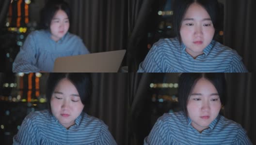 一个亚洲女人用笔记本电脑加班到深夜高清在线视频素材下载