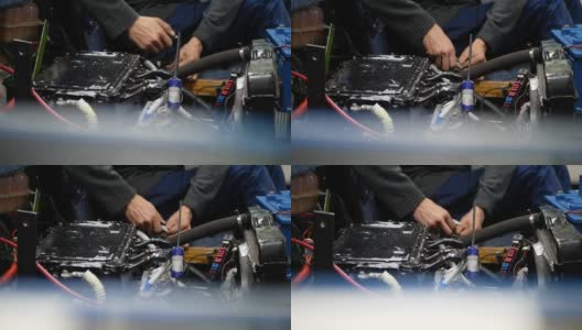 一个年轻人的手的特写，一个修理汽车引擎的机械师高清在线视频素材下载