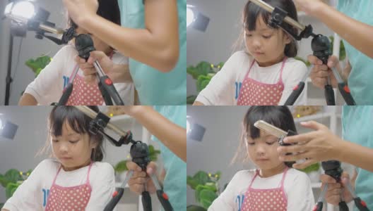 亚洲女孩拍摄视频，她的姐姐在家自制饼干，为病毒视频或TikTok在家，新一代的时尚生活理念。高清在线视频素材下载