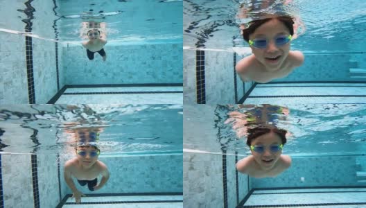 亚洲男孩在游泳池的水下玩耍和游泳高清在线视频素材下载