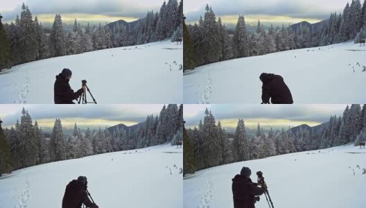 在冬季山区，摄影师带着三脚架上的相机高清在线视频素材下载