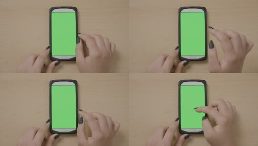 年轻女商人用智能手机在绿色触摸屏上做滚动和滑动手势的俯视图高清在线视频素材下载