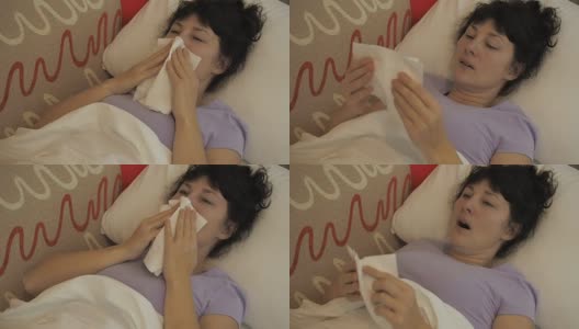 一个生病的女人坐在家里的沙发上打喷嚏。女孩流鼻涕，拿纸巾，流感症状。医疗保健和医疗理念。感冒是流感的感染。高清在线视频素材下载