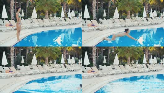在一个阳光明媚的夏日，年轻的黑发女子穿着比基尼跳进游泳池高清在线视频素材下载