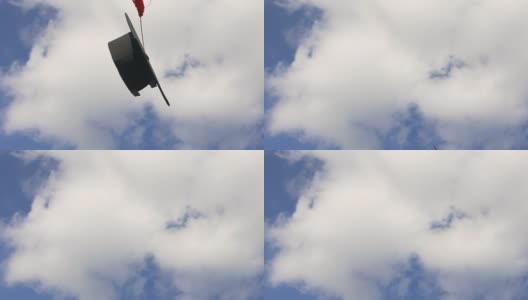 带流苏的学术帽在蓝天的背景下飞起来高清在线视频素材下载