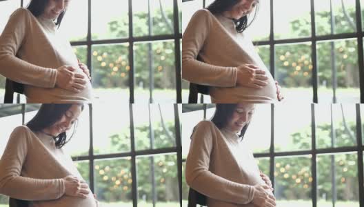 孕妇轻轻抚摸着肚子，怀孕/分娩高清在线视频素材下载