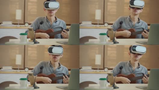 亚洲人使用VR耳机在家里在线教吉他高清在线视频素材下载