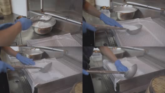 厨师的手将糯米卷倒在蒸笼上高清在线视频素材下载
