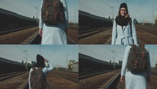 女孩Sunny day背着背包走在铁轨上。高清在线视频素材下载