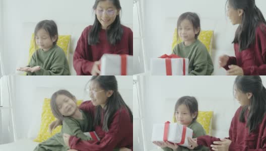 亚洲女孩在家里赠送礼盒给姐姐，庆祝节日节日。高清在线视频素材下载