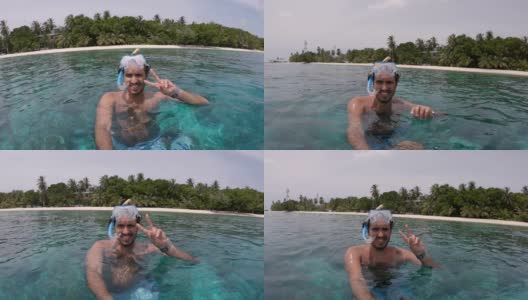 一个年轻的成年男子在度假时自拍——在马尔代夫戴着潜水面罩高清在线视频素材下载