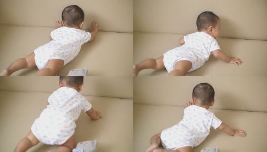 婴儿在地板上爬行和玩耍高清在线视频素材下载