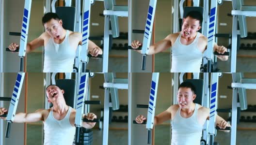 滑稽的亚洲人正在健身房用滑稽和幽默的表情锻炼高清在线视频素材下载