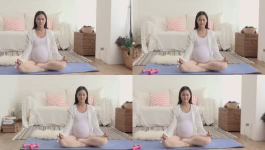 孕妇在运动垫上练习瑜伽高清在线视频素材下载