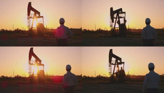 日落时分，DS工程师站在油井旁高清在线视频素材下载