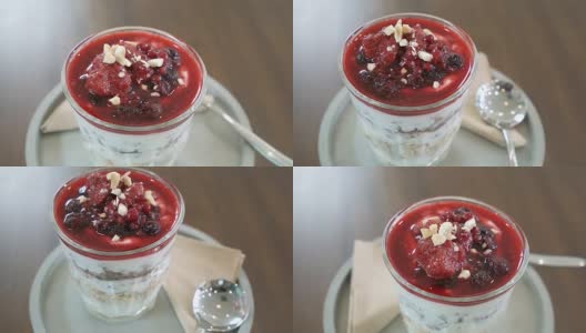 旋转格兰诺拉麦片杯与水果和草莓酱。高清在线视频素材下载