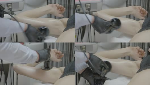 年轻女性手臂的特写有皮肤恢复和紧致治疗与射频设备在诊所沙龙高清在线视频素材下载