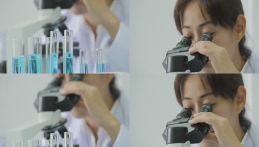 在实验室里通过显微镜观察的亚洲女性医学研究科学家高清在线视频素材下载