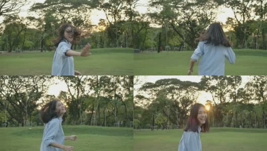 慢动作拍摄的年轻迷人的亚洲女人在一个夏天的公园在日落。美丽的女孩在户外享受大自然。高清在线视频素材下载