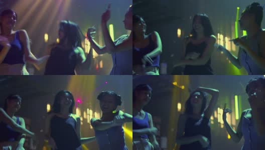 一群年轻美丽的亚洲女子在夜总会喝酒，随着dj的音乐跳舞。漂亮的女朋友享受夜生活，在迪斯科舞会上一起疯狂跳舞高清在线视频素材下载