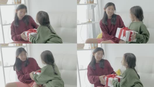 快乐的亚洲女孩在家里一起争夺礼盒，庆祝节日的概念。高清在线视频素材下载