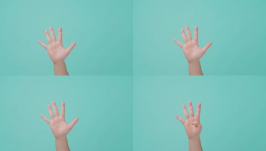 人的手举起的特写镜头，做出用手指倒数的手势。用手掌打旗号或做手势的人。在孤立的蓝屏背景中看到。高清在线视频素材下载