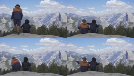 一对夫妇从约塞米蒂国家公园的冰川点看公园和瀑布。美国加利福尼亚州高清在线视频素材下载