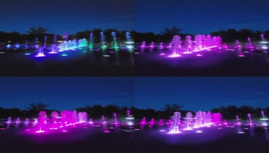 五彩缤纷的灯光音乐舞蹈城市喷泉。喷泉的碎片。明确多彩水。以公园为背景。晚上的时间。垂直新西伯利亚高清在线视频素材下载