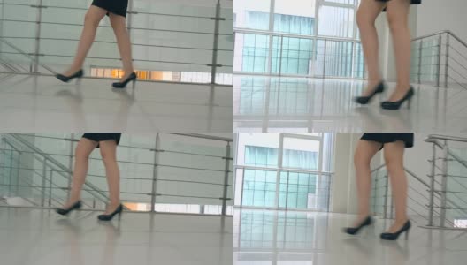女商人穿着高跟鞋走在办公室的走廊里高清在线视频素材下载