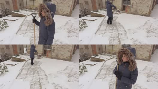 在工作前拿着雪铲的女人高清在线视频素材下载