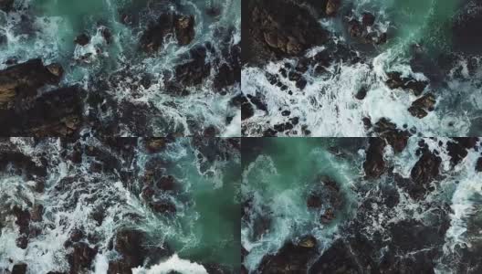 海浪撞击着黑色的岩石-鸟瞰图高清在线视频素材下载