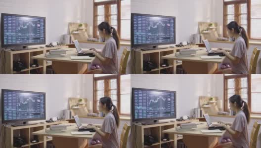 亚洲女性工作在家里作为交易员和财务顾问使用笔记本电脑做她的家庭预算高清在线视频素材下载