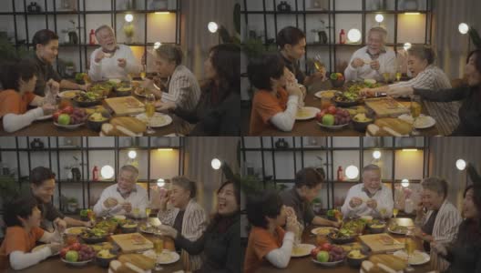 亚洲家庭在家里的餐桌上吃晚餐高清在线视频素材下载