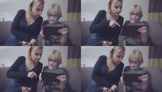 母亲和她的儿子在数码平板电脑上玩慢动作素材视频高清在线视频素材下载